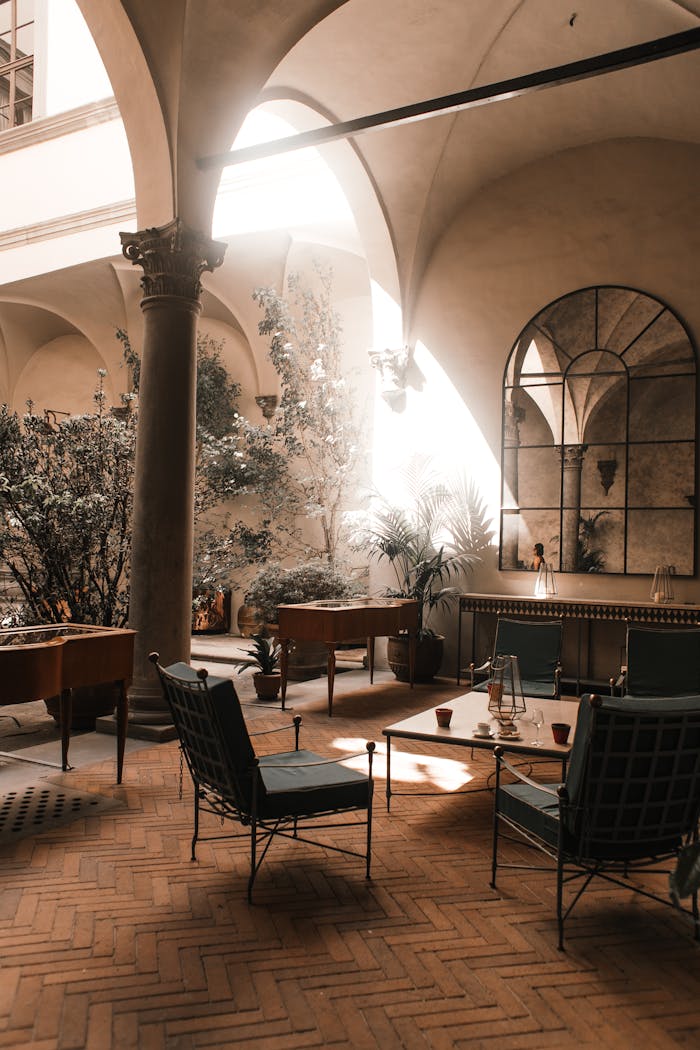Capture of a stylish courtyard with elegant furnishings in a historical architectural setting.